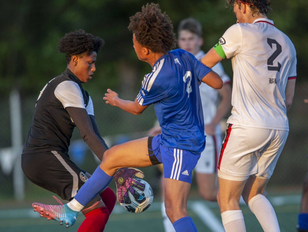 Shorewood’s Jackson Smith is beat to the ball by Ballard’s goalkeeper during the game against Ballard on Thursday, May 18, 2023 in Shoreline, Washington. (Olivia Vanni / The Herald)
