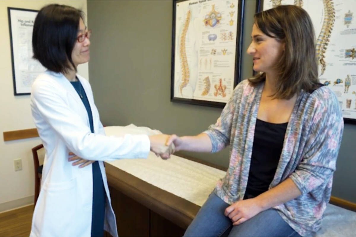 Dr. Yee with a patient.