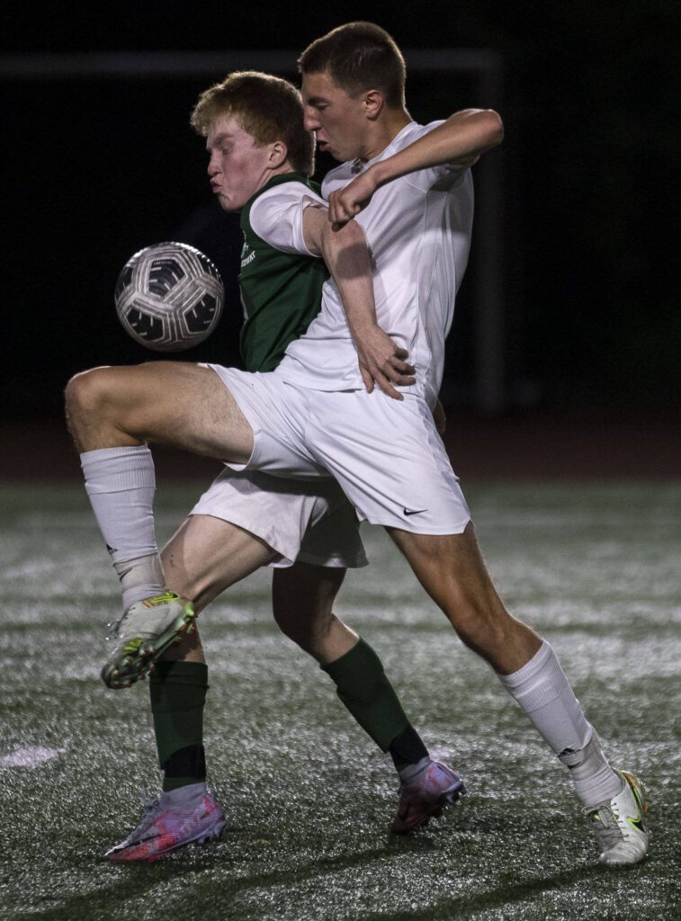 Edmonds-Woodway’s Ben Hanson (10) and Mead’s Kye Welch (9) fight for the ball during a game between Edmonds-Woodway and Mead at Edmonds-Wooday High School in Edmonds, Washington on Friday, May 19, 2023. Edmonds-Woodway won, 2-0. (Annie Barker / The Herald)
