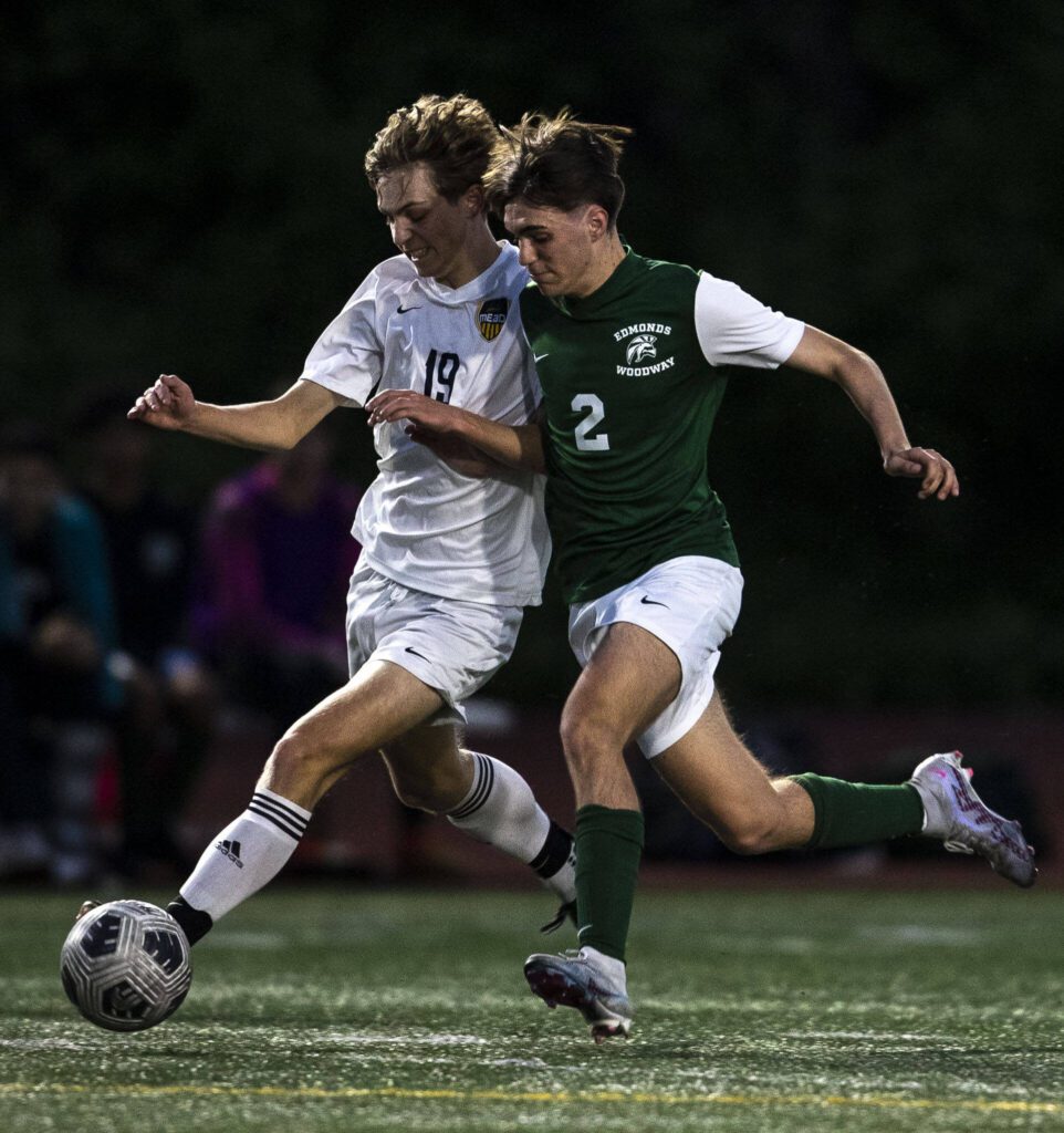 Edmonds-Woodway’s Alexander Bryan (2) and Mead’s Jackson Grayhek (19) fight for the ball during a game between Edmonds-Woodway and Mead at Edmonds-Wooday High School in Edmonds, Washington on Friday, May 19, 2023. Edmonds-Woodway won, 2-0. (Annie Barker / The Herald)
