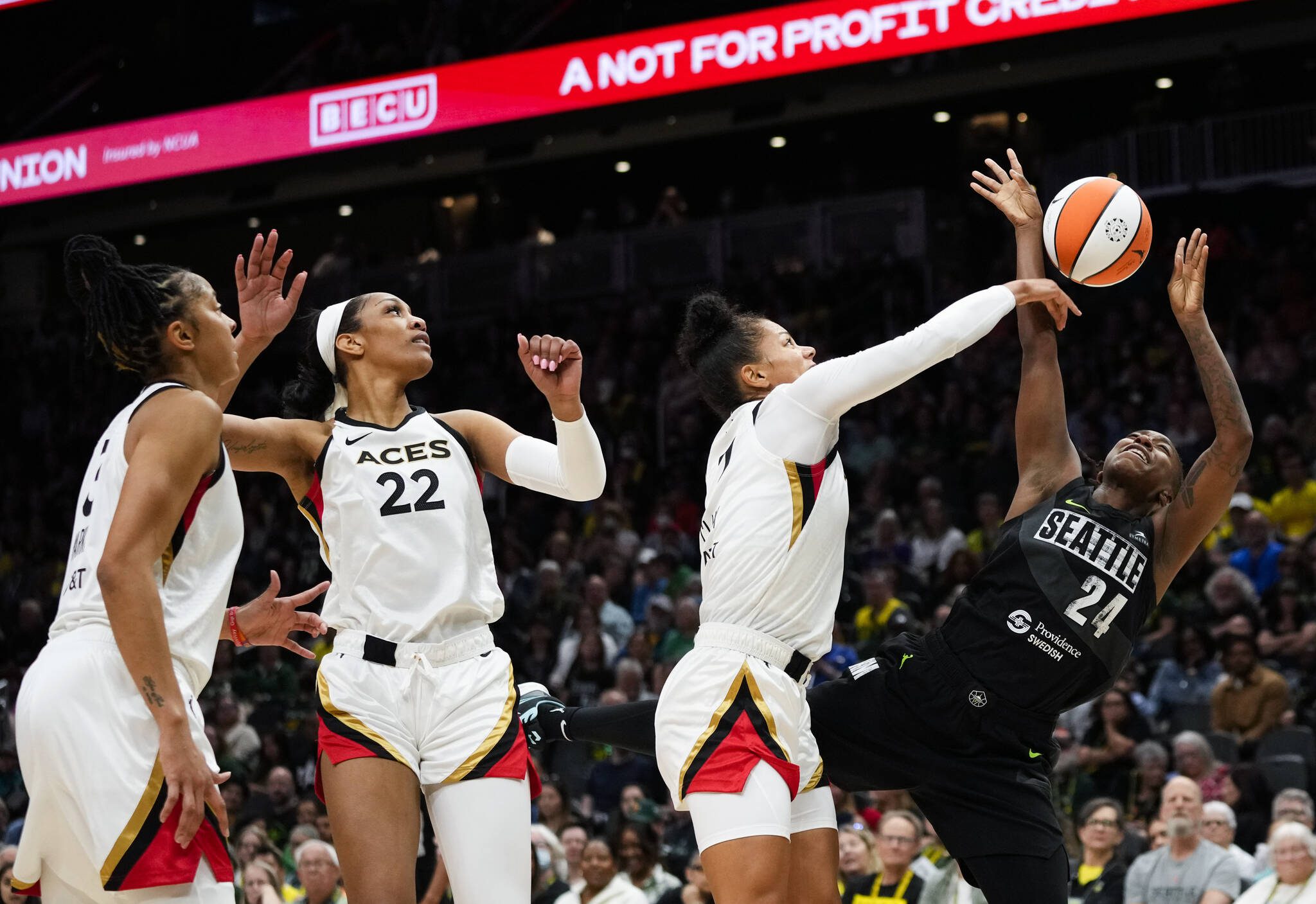 Storm guard Jewell Loyd (24) has her shot blocked by Aces forward Alysha Clark (7) as forward A’ja Wilson (22) and forward Candace Parker look on during the first half of a game Saturday in Seattle. (AP Photo/Lindsey Wasson)