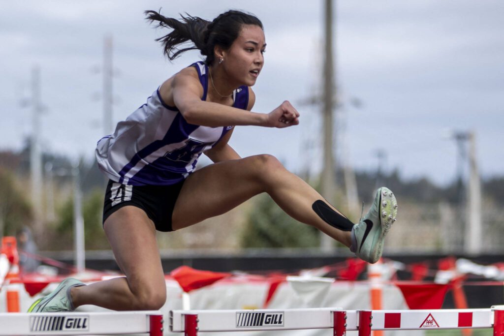 Kamiak’s Kalia Estes races during a 100-meter hurdles prelims race at the Eason Invitational at Veterans Memorial Stadium in Snohomish on April 22. (Annie Barker / The Herald)
