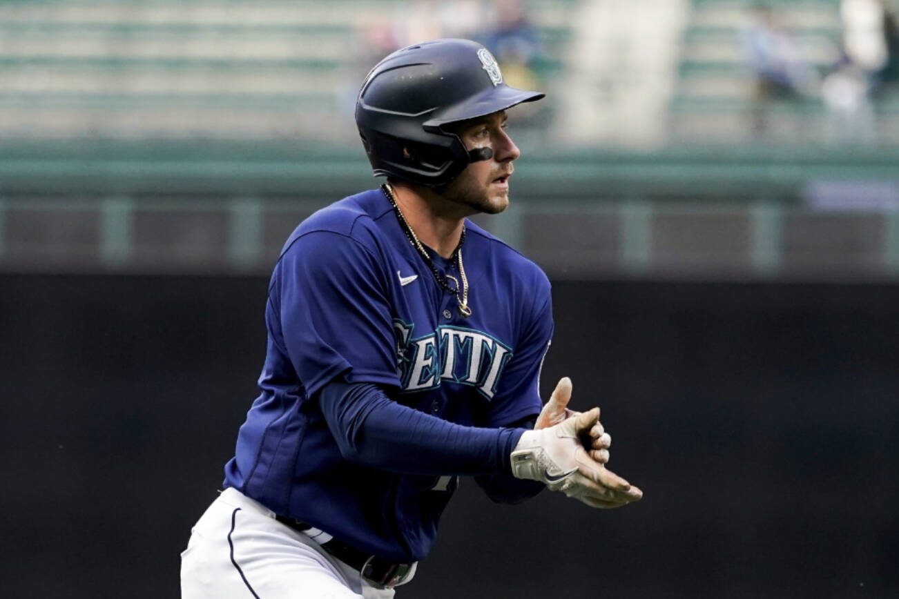 Seattle Mariners' Jarred Kelenic claps as he runs the bases after hitting a two-run home run against the Oakland Athletics during the first inning of a baseball game Monday, May 22, 2023, in Seattle. (AP Photo/Lindsey Wasson)