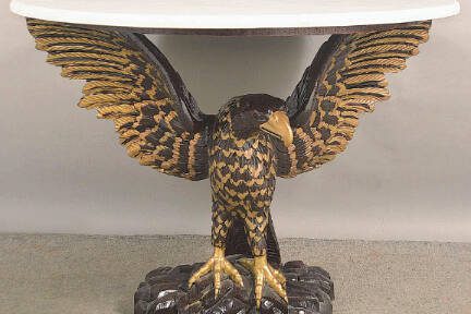 Eagles are a powerful symbol in American designs from the Great Seal to everyday decorative arts. A carved eagle holds up this table’s faux marble top.