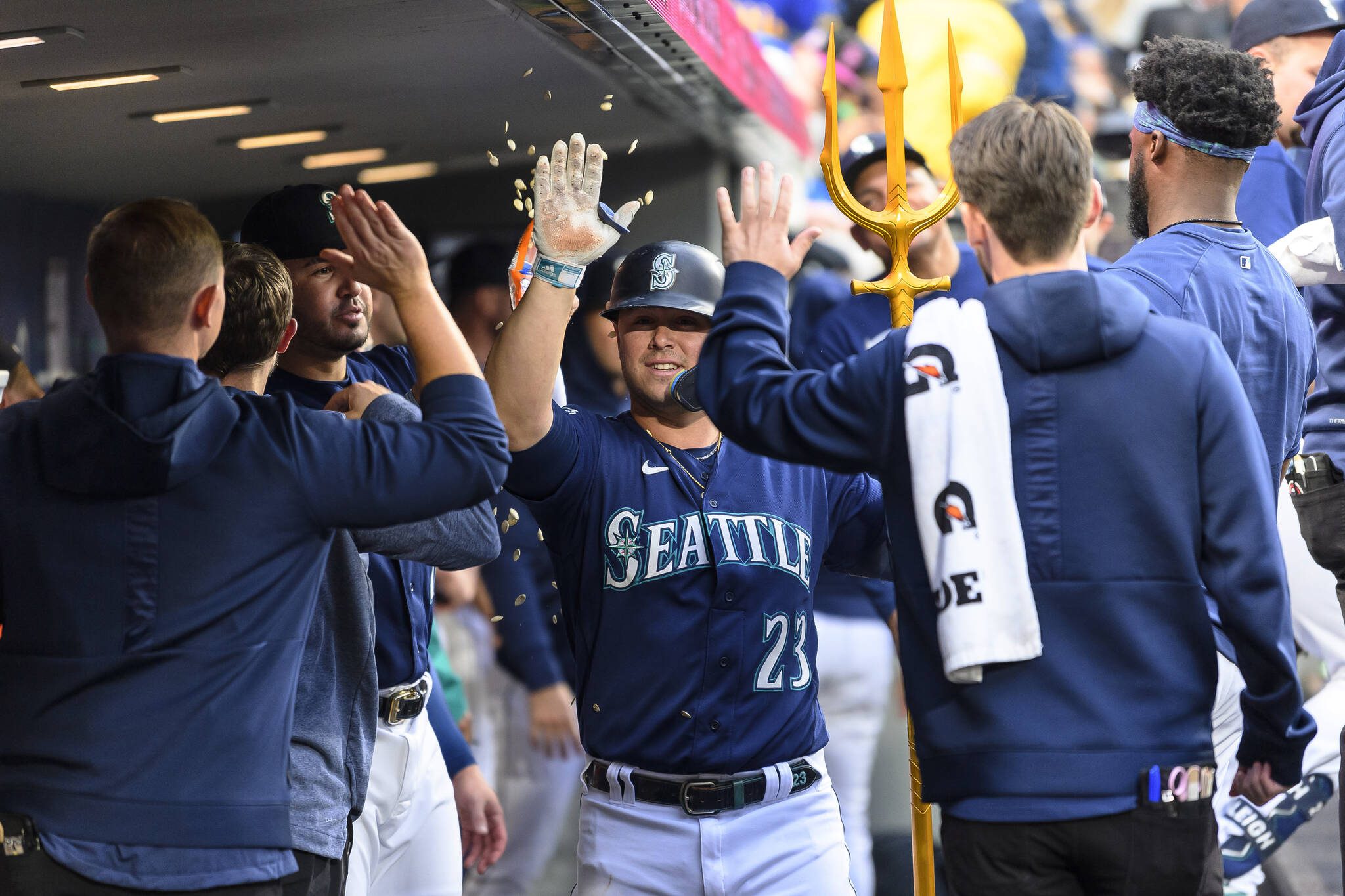 The Mariners’ Ty France (23) is congratulated in the dugout after his home run against the Athletics during the fifth inning of a game Tuesday in Seattle. (AP Photo/Caean Couto)