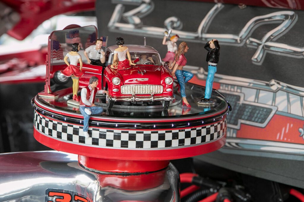 Figurines decorate an engine block of a Chevy Bel Air during Cruzin’ to Colby in Everett in 2022. (Kevin Clark / The Herald)
