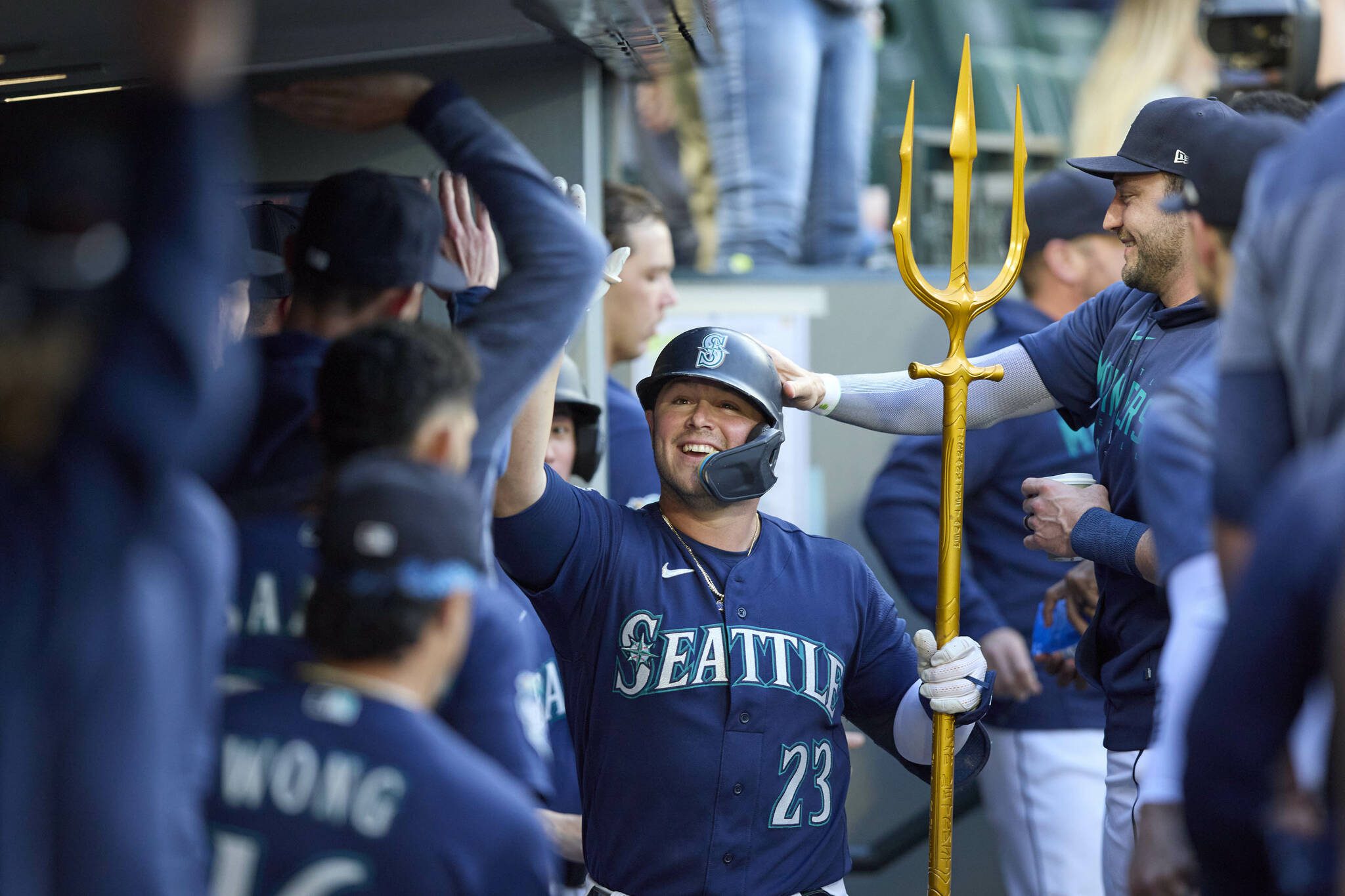 The Mariners’ Ty France celebrates in the dugout after his solo home run during the sixth inning of a game aginst the Athletics on Thursday in Seattle. (AP Photo/John Froschauer)