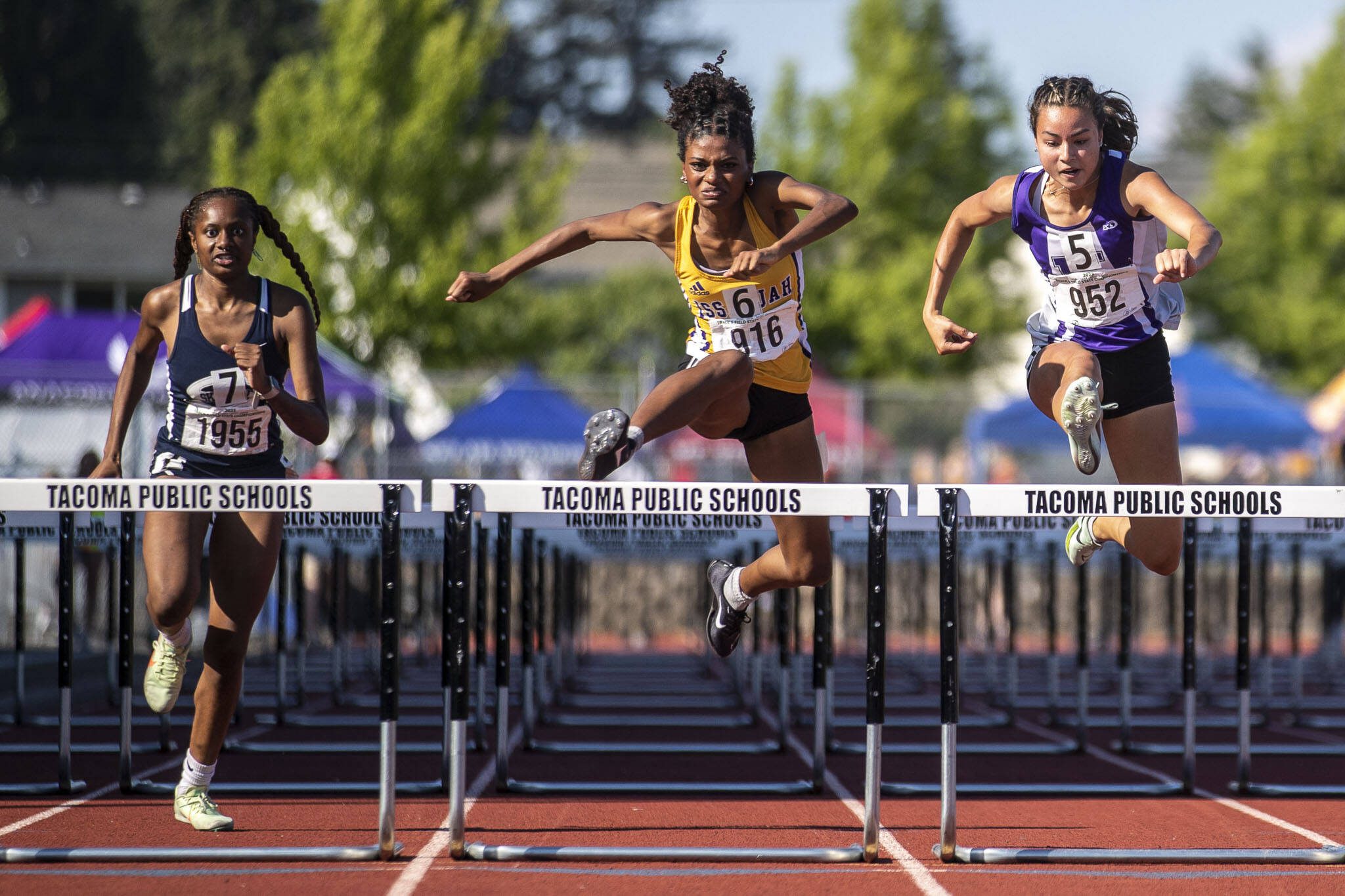 Kamiak’s Kalia Estes, right, places fourth in heat 3 of the girls 100 meter hurdle finals at Mount Tahoma High School in Tacoma, Washington on Friday, May 26, 2023. (Annie Barker / The Herald)