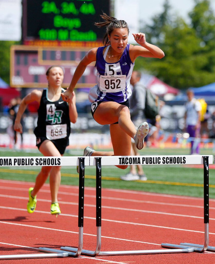 Kamiak senior Kalia Estes clears a hurdle on her way to a state championship in the girls 4A 300 meter hurdle during the WIAA State Track and Field Championships on Saturday, May 27, 2023, at Mount Tahoma High School in Tacoma, Washington. Estes won by one-hundredth of a second. (Ryan Berry / The Herald)
