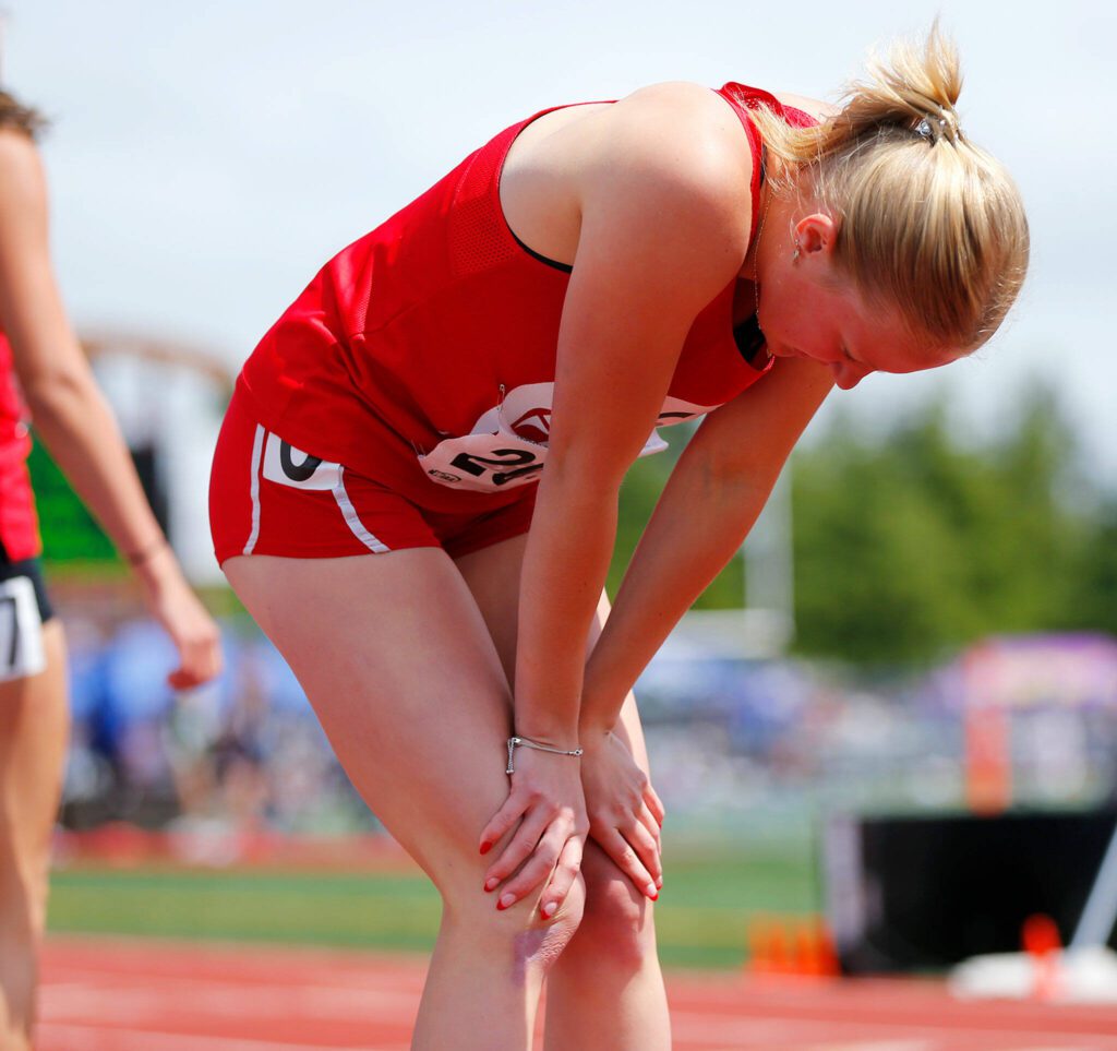 Stanwood senior Abigail Danielson catches her breath after the 3A girls 300 meter hurdles during the WIAA State Track and Field Championships on Saturday, May 27, 2023, at Mount Tahoma High School in Tacoma, Washington. (Ryan Berry / The Herald)
