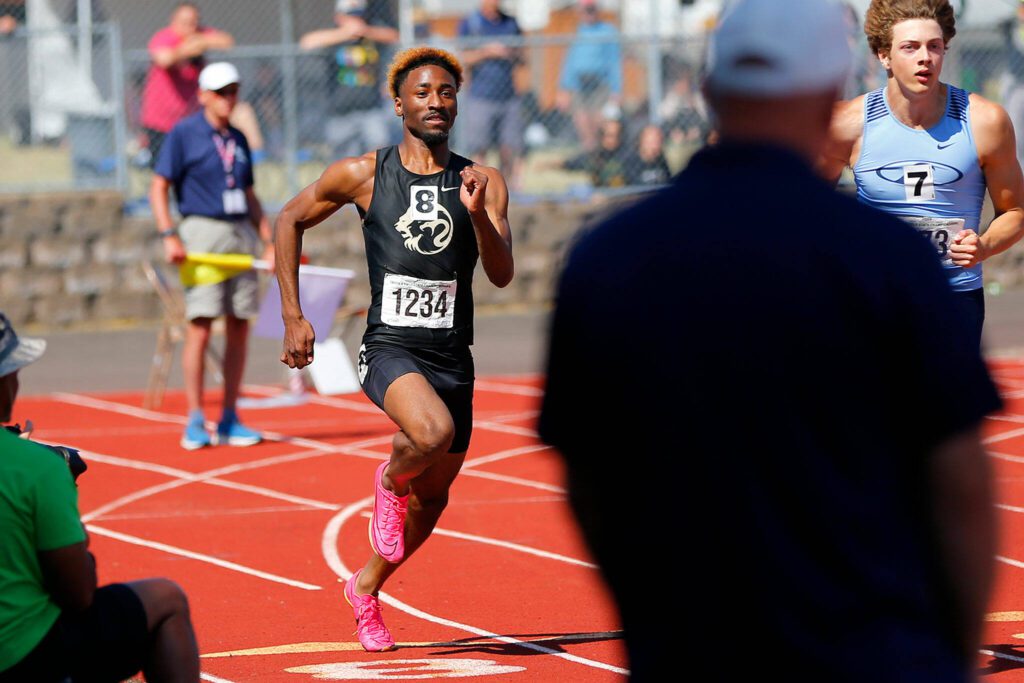 Lynnwood senior Jordan Whittle makes the turn in the 3A boys 200 meter dash during the WIAA State Track and Field Championships on Saturday, May 27, 2023, at Mount Tahoma High School in Tacoma, Washington. (Ryan Berry / The Herald)
