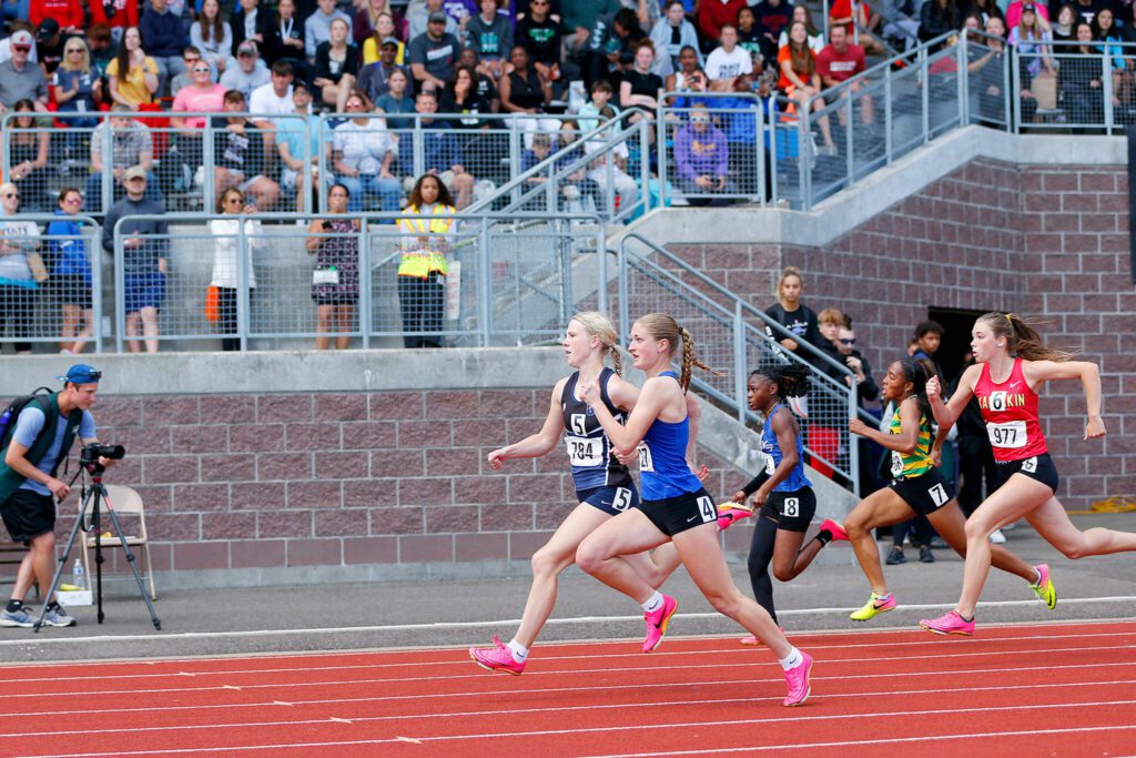 Glacier Peak senior Jana Willems, lane 5, runs neck and neck with Brooke Lyons of Tahoma before claiming first place in the 4A girls 100 meter dash during the WIAA State Track and Field Championships on Saturday, May 27, 2023, at Mount Tahoma High School in Tacoma, Washington. (Ryan Berry / The Herald)
