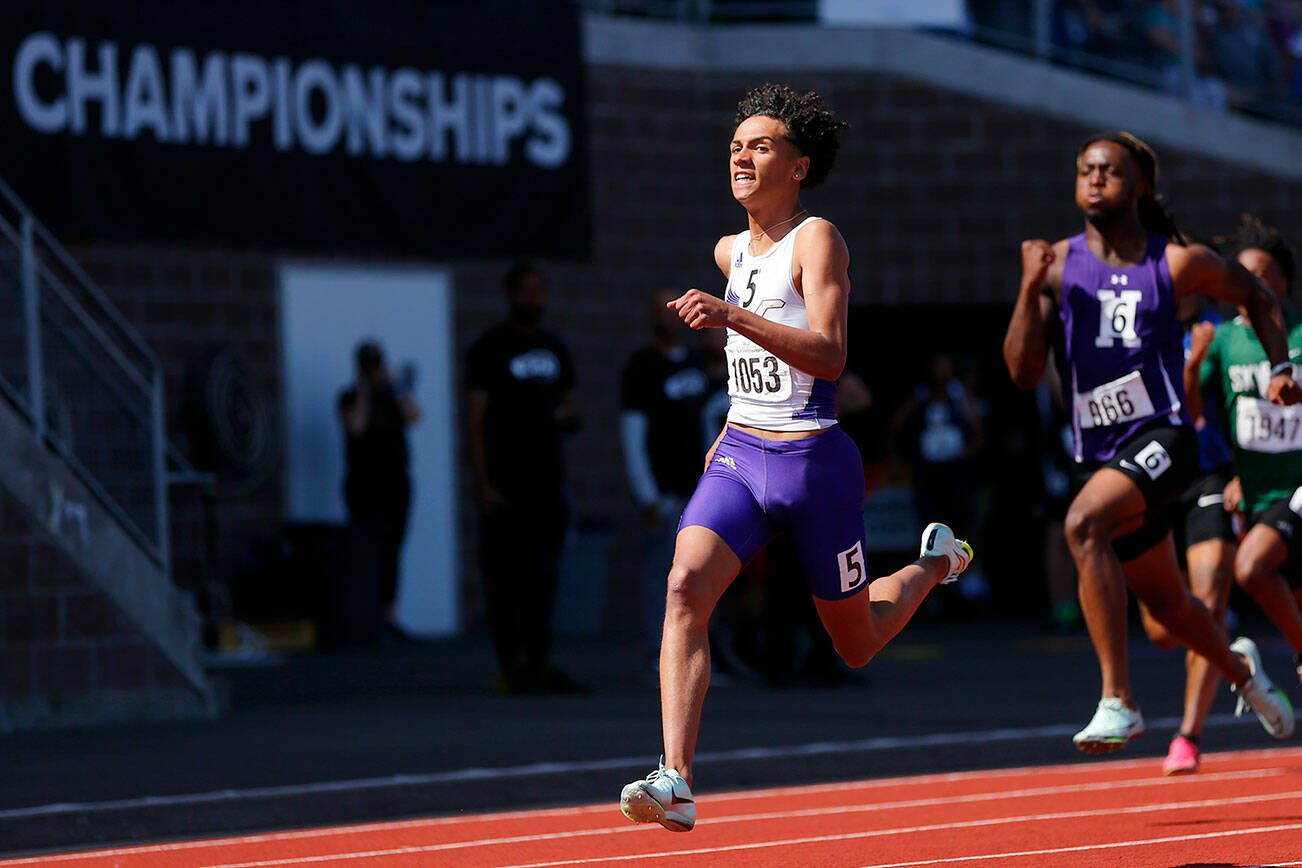 Lake Stevens’ Grant Buckmiller takes a peek at the clock as he runs to the title in the 4A boys 200 meter dash during the WIAA State Track and Field Championships on Saturday, May 27, 2023, at Mount Tahoma High School in Tacoma, Washington. (Ryan Berry / The Herald)