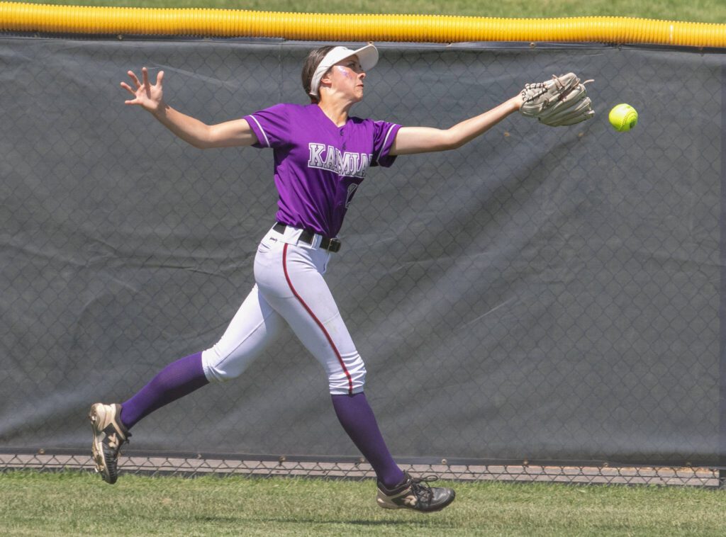 Kamiak’s Tyler Karabach (11) reaches for a fly ball to center field in the sixth inning during a 4A state softball consolation game against Bothell on Saturday in Richland. (TJ Mullinax / For The Herald)
