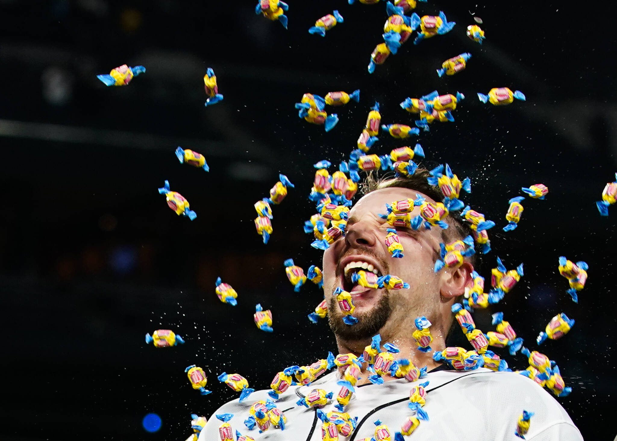 The Mariners’ Cal Raleigh smiles as a teammate throws bubblegum at him during an interview after Raleigh hit a single to drive in the winning run against the Yankees during the 10th inning of a game Wednesday in Seattle. (AP Photo/Lindsey Wasson)