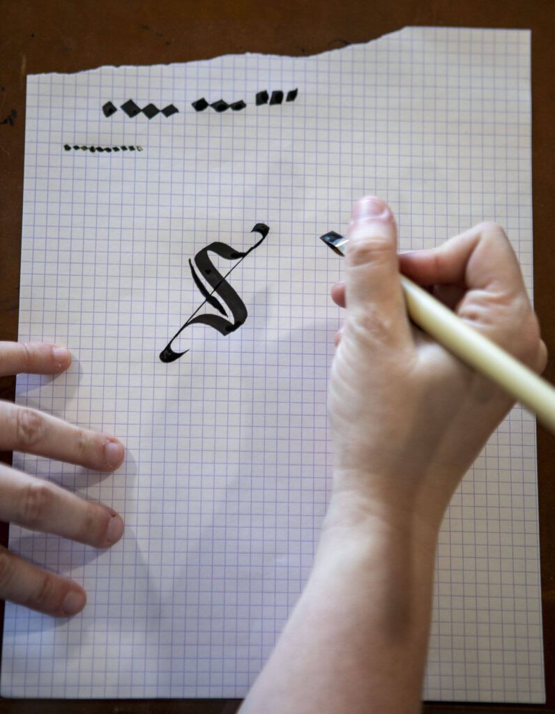 Chelsea Bridges Wagner, 35, practices calligraphy at her home in Snohomosh, Washington on Wednesday, March 29, 2023. (Annie Barker / The Herald)
