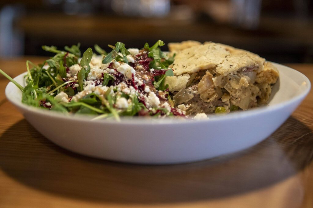 The steak pot pie and salad at Pie Dive Bar. (Annie Barker / The Herald)
