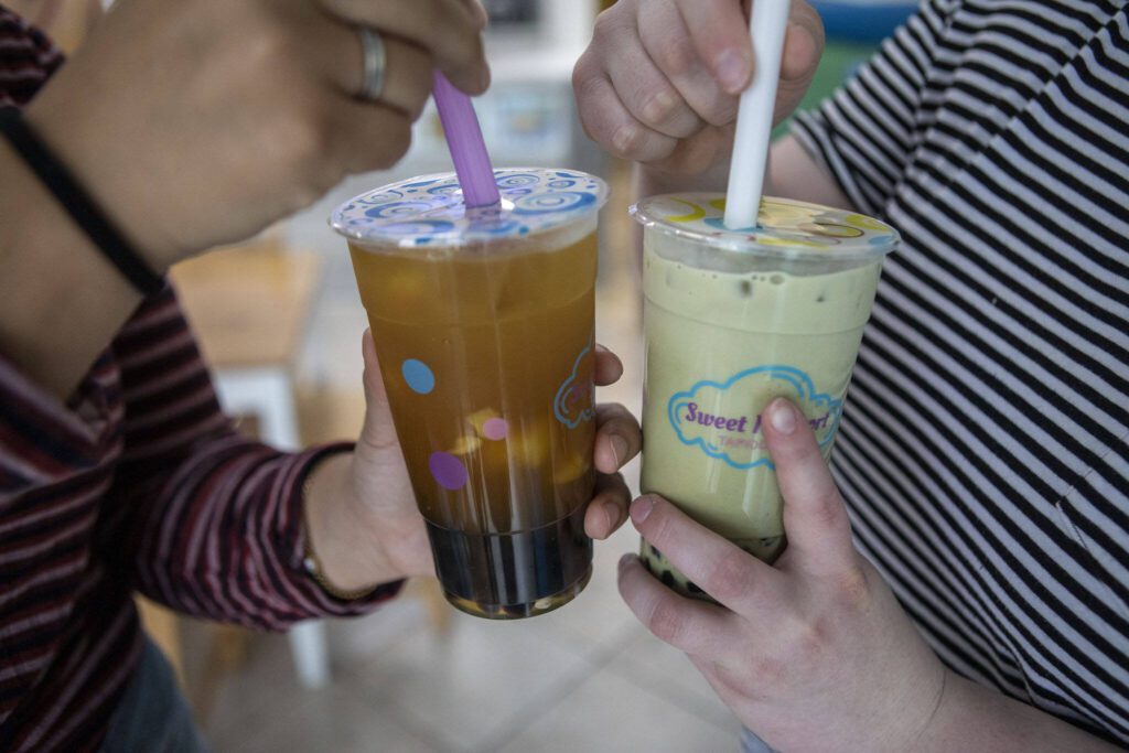 Cups of mango green tea, left, and matcha, right, at Sweet N Short Tapioca Tea in Everett, Washington on Tuesday, May 30, 2023. (Annie Barker / The Herald)
