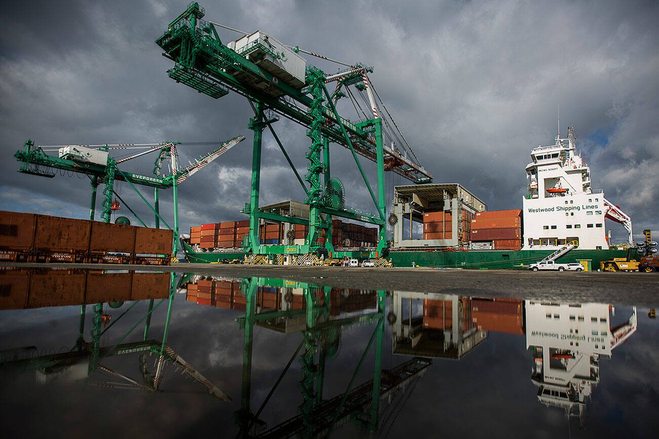 The 214-foot tall cranes work to unload their first cargo shipments at South Terminal at the Port of Everett on Thursday, April 8, 2021 in Everett, Wa. (Olivia Vanni / The Herald)