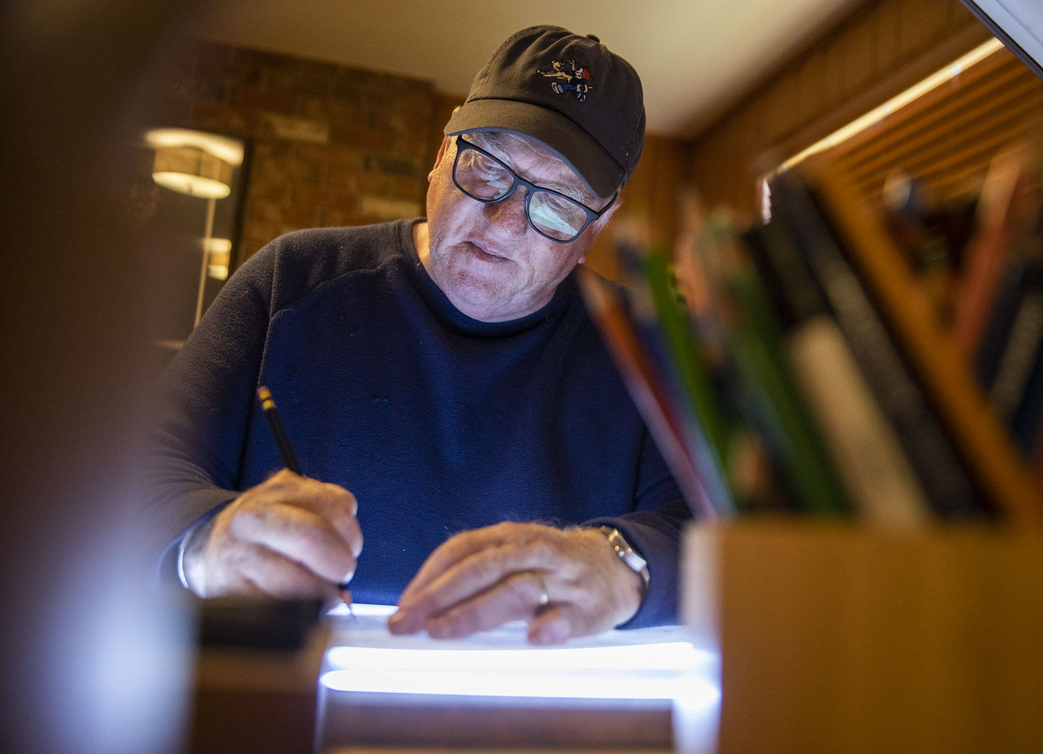 Brian Basset, creator of “Red and Rover,” works on an upcoming Sunday comic in his studio on Wednesday, June 7, 2023, in Edmonds, Washington. (Olivia Vanni / The Herald)