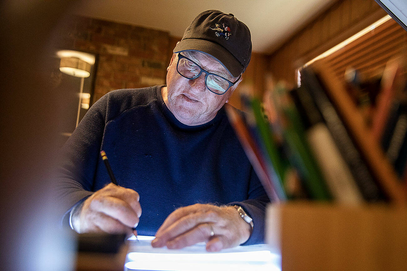 Brian Basset, creator and cartoonist of Red and Rover, works on an upcoming Sunday comic in his studio on Wednesday, June 7, 2023 in Edmonds, Washington. (Olivia Vanni / The Herald)