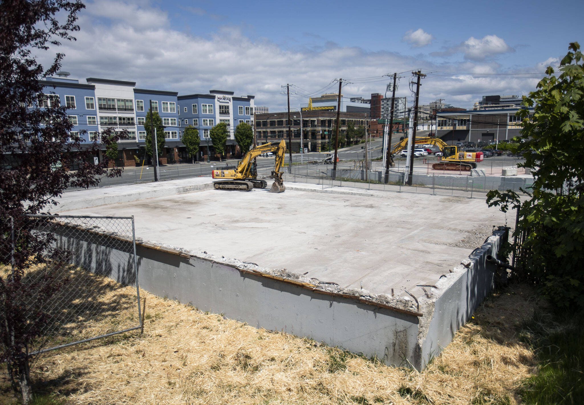 The site of a former 76 gas station, seen here Wednesday, May 31, 2023, and a handful of century-old buildings will be the location for new apartment buildings at the corner of Pacific and Rucker avenues in Everett, Washington. (Olivia Vanni / The Herald)