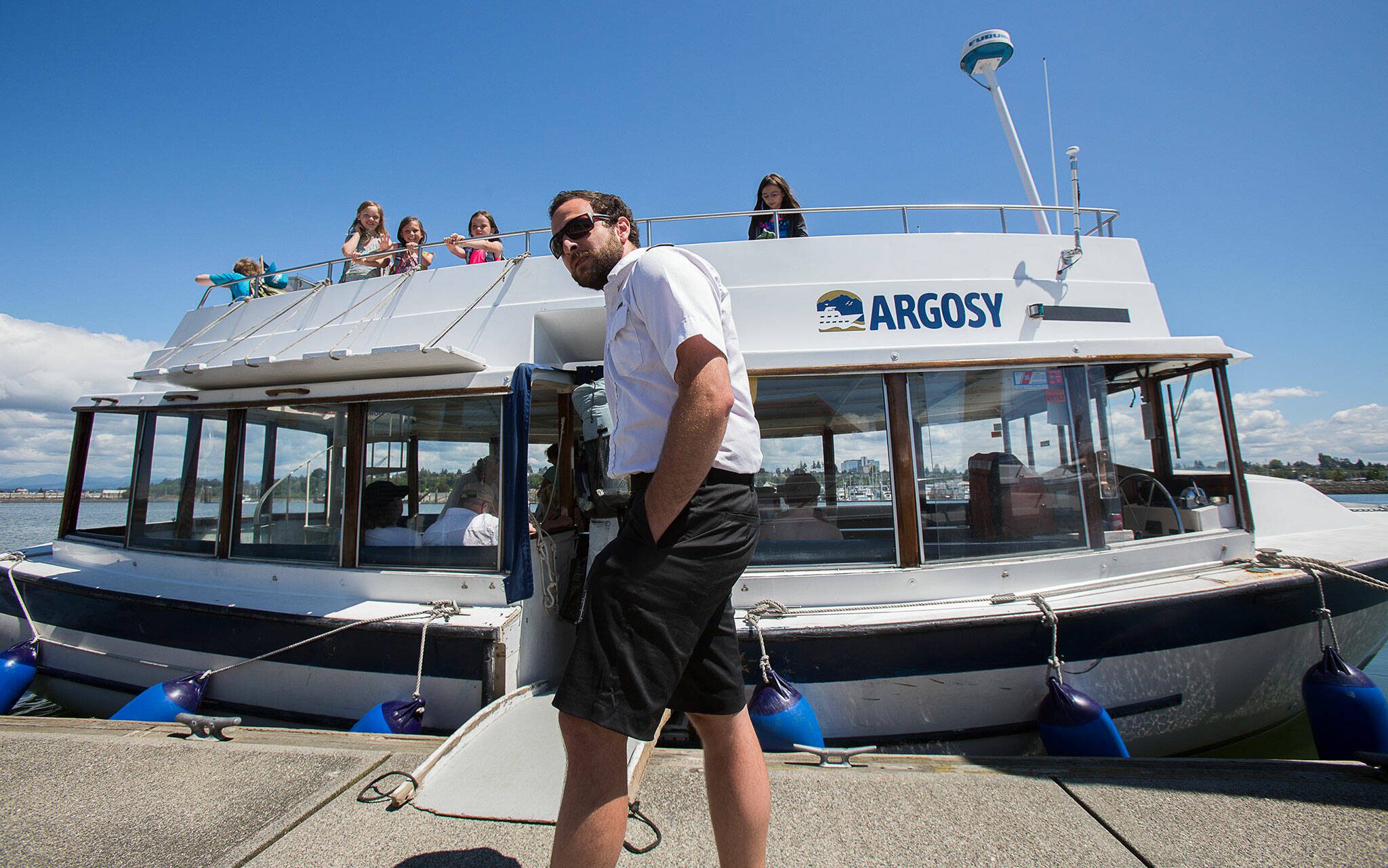 One of the Jetty Island ferry captains waits for boarders as the ferry begins operations for the summer on Wednesday, Jul. 6, 2016 in Everett, Washington. (Andy Bronson / The Herald)