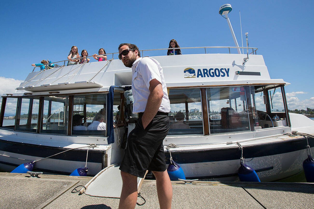 One of the Jetty Island ferry captains waits for boarders as the ferry begins operations for the summer on Wednesday, Jul. 6, 2016 in Everett. (Andy Bronson / The Herald)