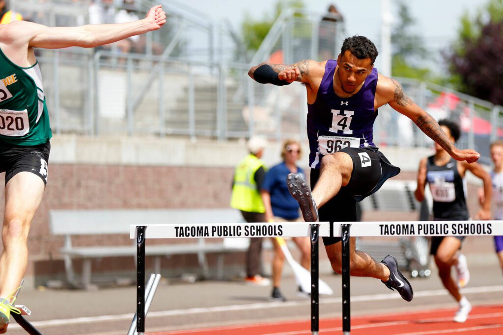 Kamiak senior Jaquan Means closes in on the competition in the Class 4A boys 300-meter hurdles during the state track and field championships May 27 at Mount Tahoma High School in Tacoma. The Kamiak boys track and field team finished third at state. (Ryan Berry / The Herald)
