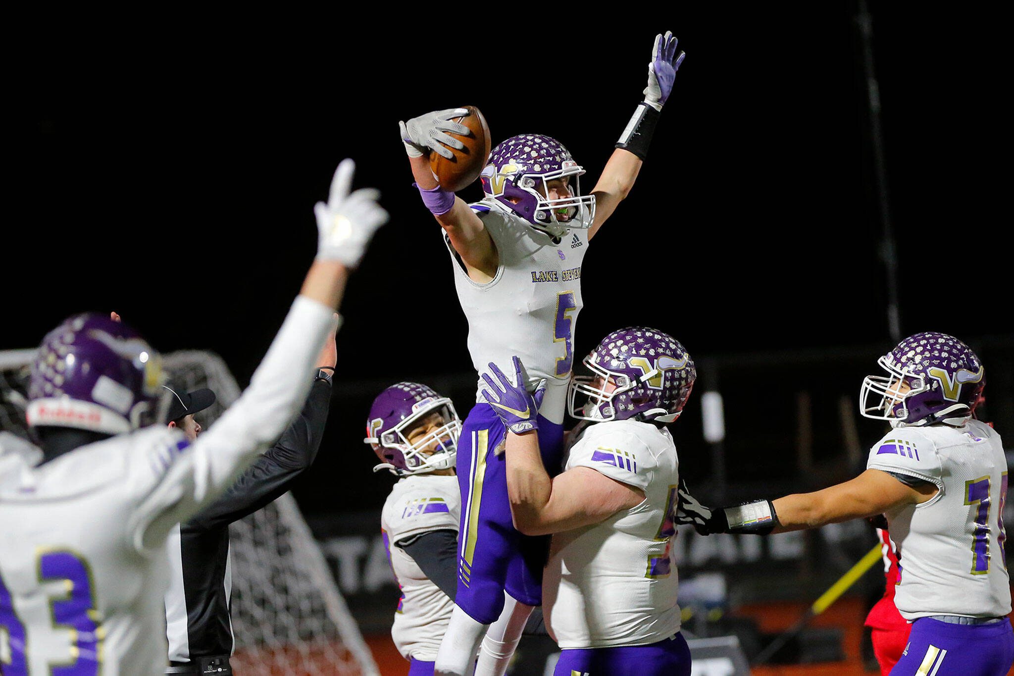 Lake Stevens’ Cole Becker celebrates a touchdown with teammates during the Class 4A state title game against Kennedy Catholic on Dec. 3, 2022, at Mount Tahoma Stadium in Tacoma. The Lake Stevens football team won the state championship. (Ryan Berry / The Herald)