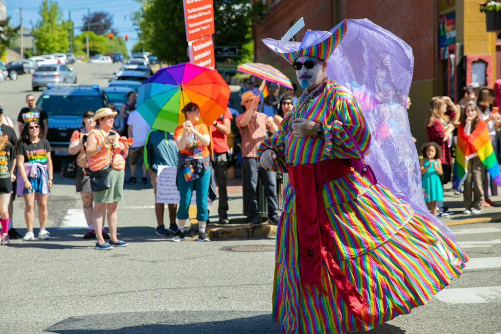 A parader passes by the judge’s table during Snohomish’s inaugural Pride celebration on Saturday, June 3, 2023, in downtown Snohomish, Washington. (Ryan Berry / The Herald)
