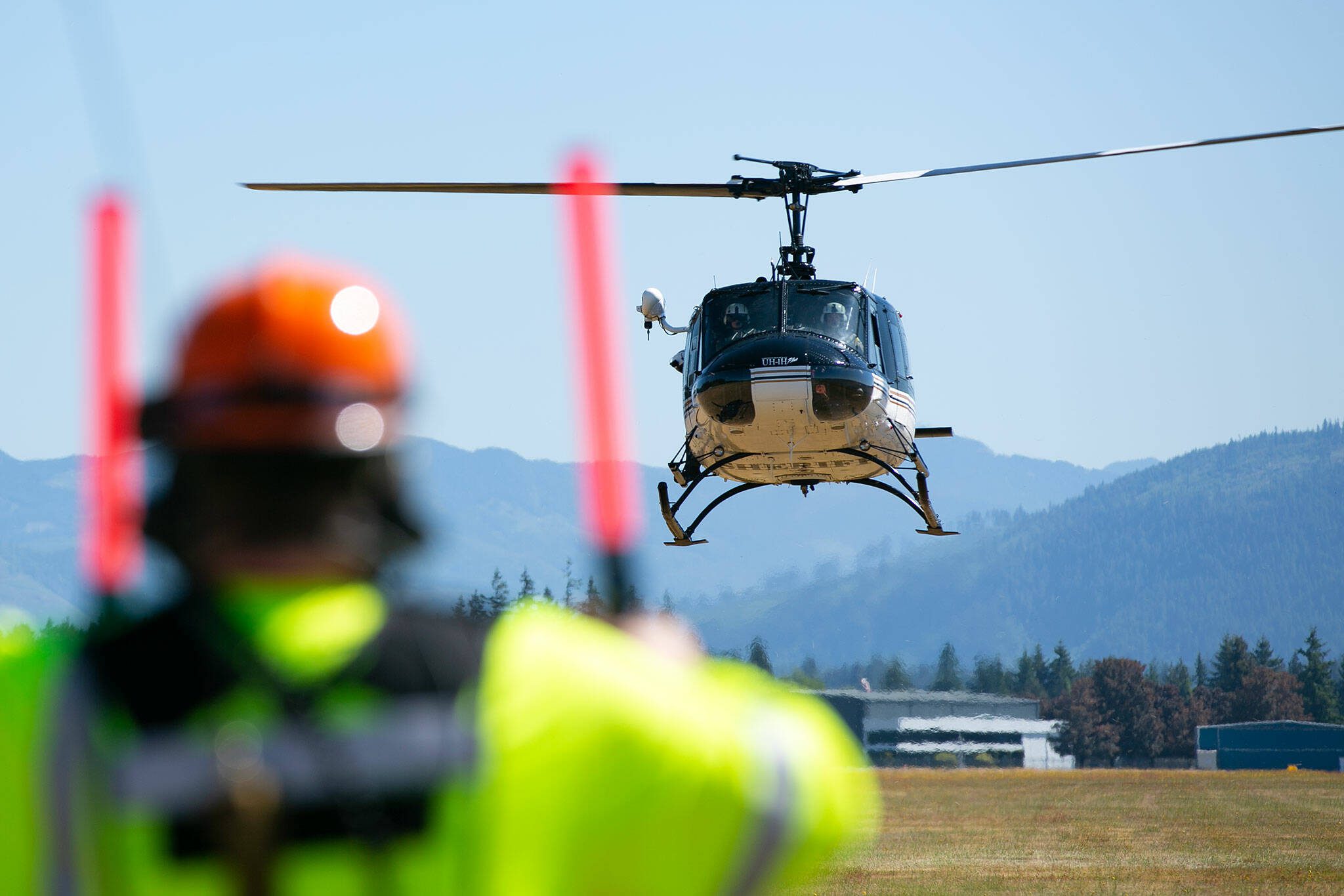 The flight crew from Snohomish County Volunteer Search and Rescue land in a field during an interagency disaster response training exercise at Arlington Municipal Airport on Tuesday, June 6, 2023, in Arlington, Washington. (Ryan Berry / The Herald)