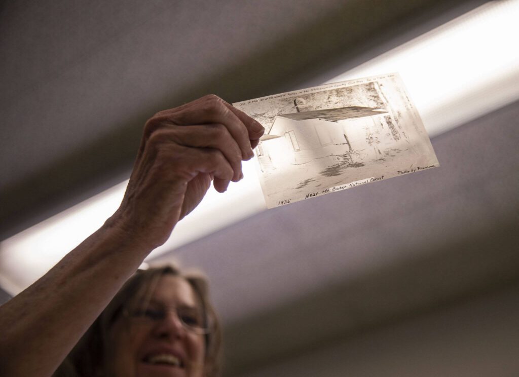 Erika Morris holds up a negative of a summer home somewhere near Mt. Baker National Forest on Tuesday, June 6, 2023 in Darrington, Washington. (Olivia Vanni / The Herald)
