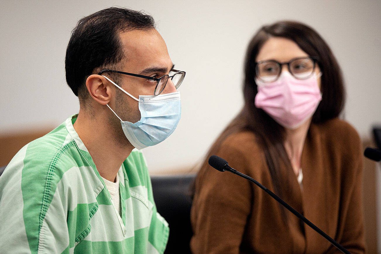 Hussein Ali, alongside attorney Laura Shaver, speaks to Judge Joseph P. Wilson during his sentencing Tuesday, Feb. 1, 2022, at the Snohomish County Superior Courthouse in Everett, Washington. (Ryan Berry / The Herald)