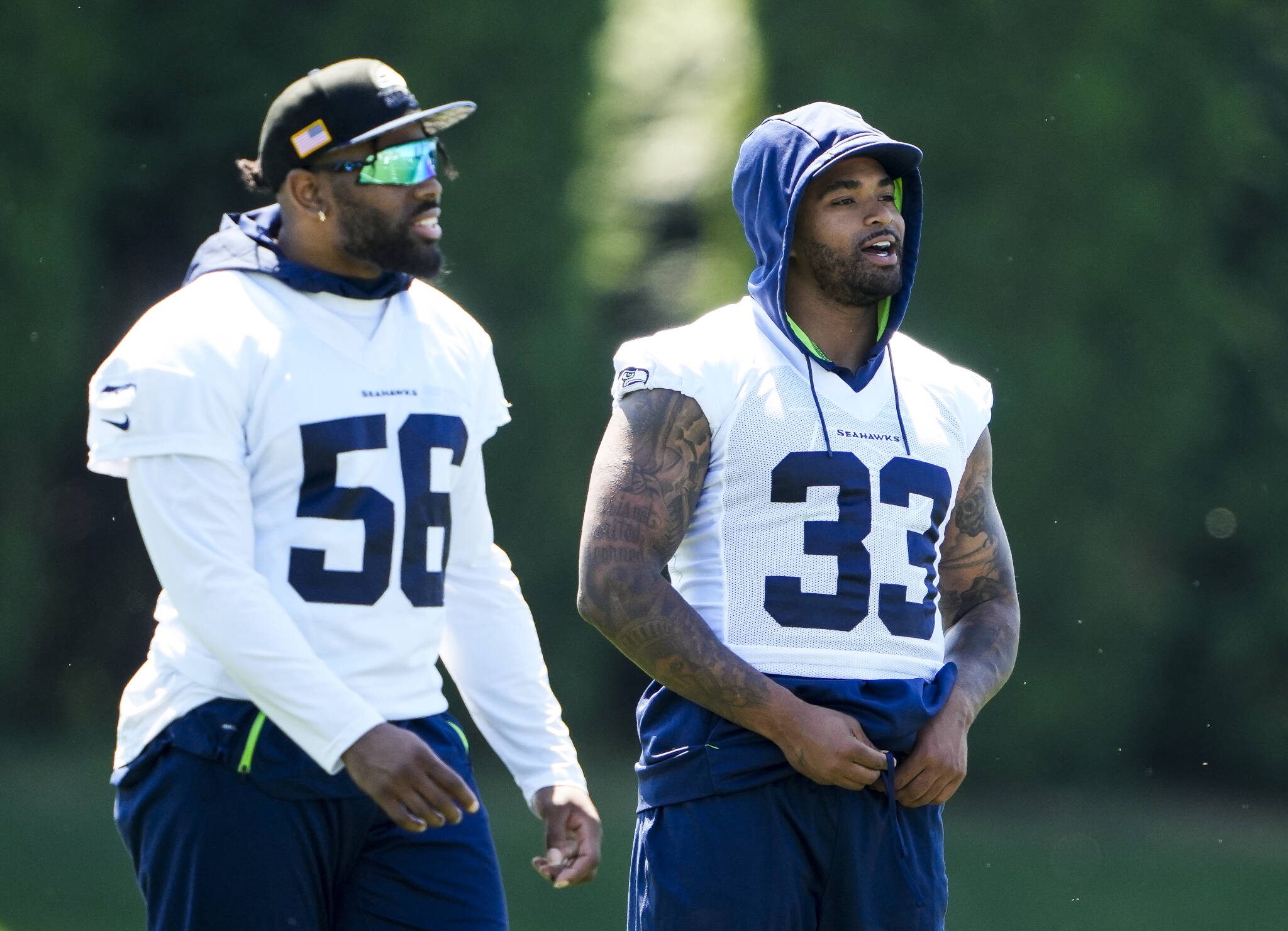 Seahawks linebacker Jordyn Brooks (56) and safety Jamal Adams (33) talk during practice Tuesday at the team’s facilities in Renton. (AP Photo/Lindsey Wasson)