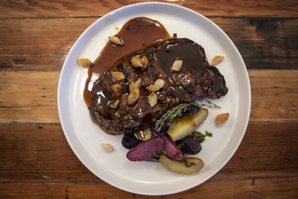 A 12-ounce ribeye steak with herb-roasted potatoes at the Bush House Inn in Index, Washington on Monday, June 26, 2023. (Annie Barker / The Herald)
