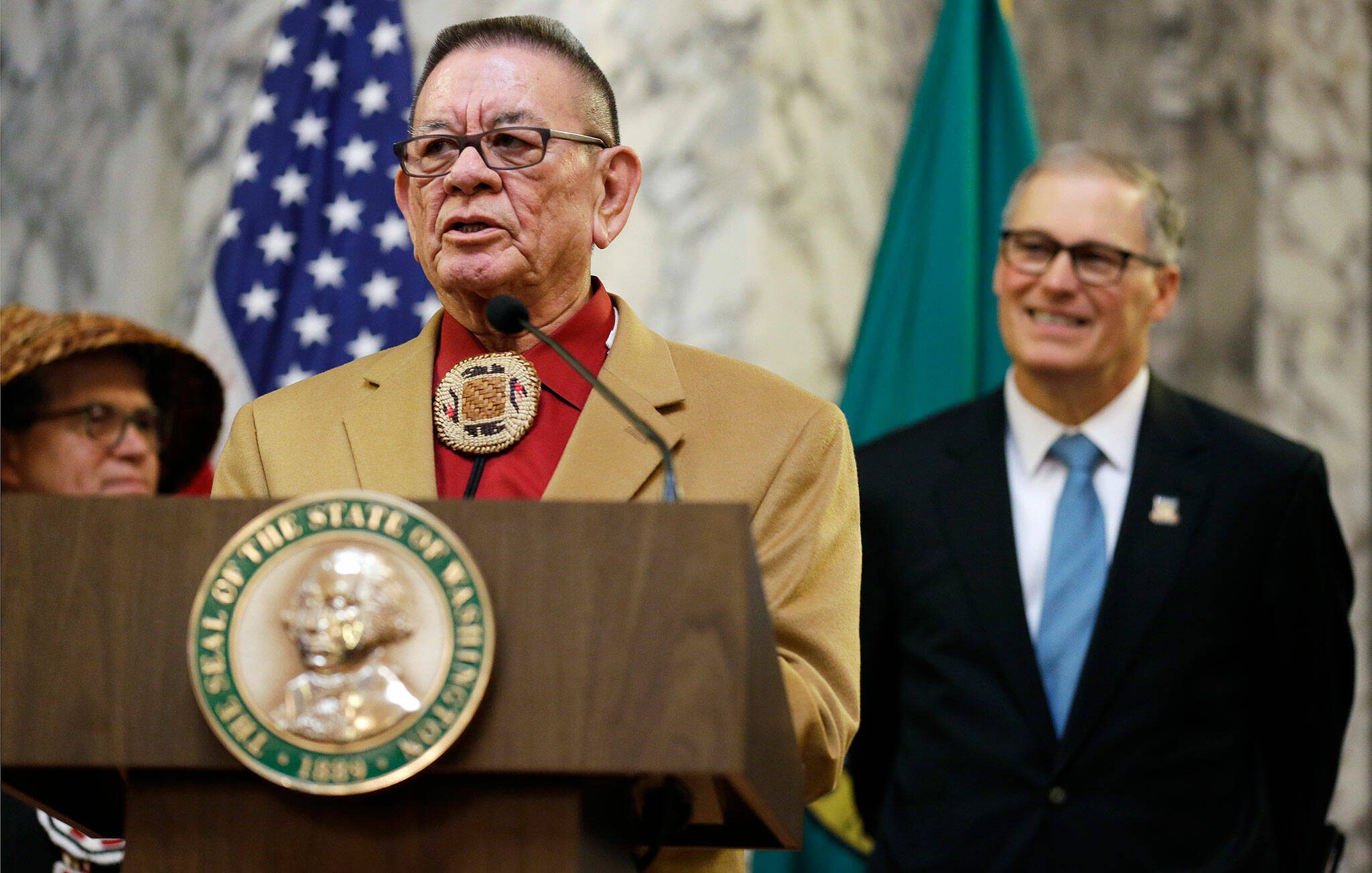 Sen. John McCoy, D-Tulalip, left, speaks Wednesday, Feb. 22, 2017, as Washington Gov. Jay Inslee, right, looks on at the Capitol in Olympia, Washington. (AP Photo/Ted S. Warren)