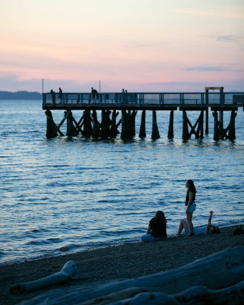 People take in the view moments after sunset at Kayak Point on Monday, June 12, 2023, in Stanwood, Washington. (Ryan Berry / The Herald)
