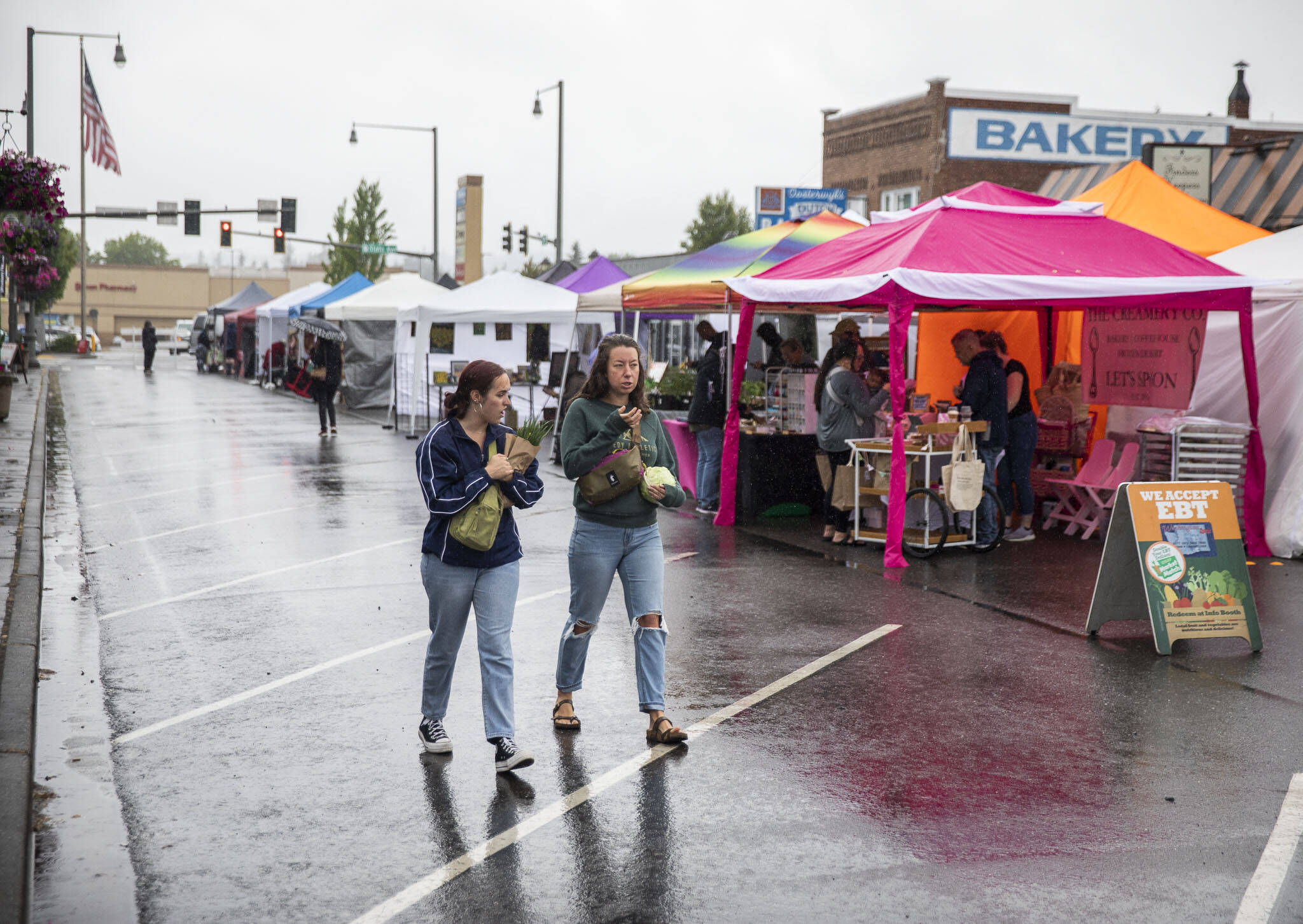 People walk through the new Marysville Farmers Market on Friday, June 9, 2023, in Marysville, Washington. (Olivia Vanni / The Herald)