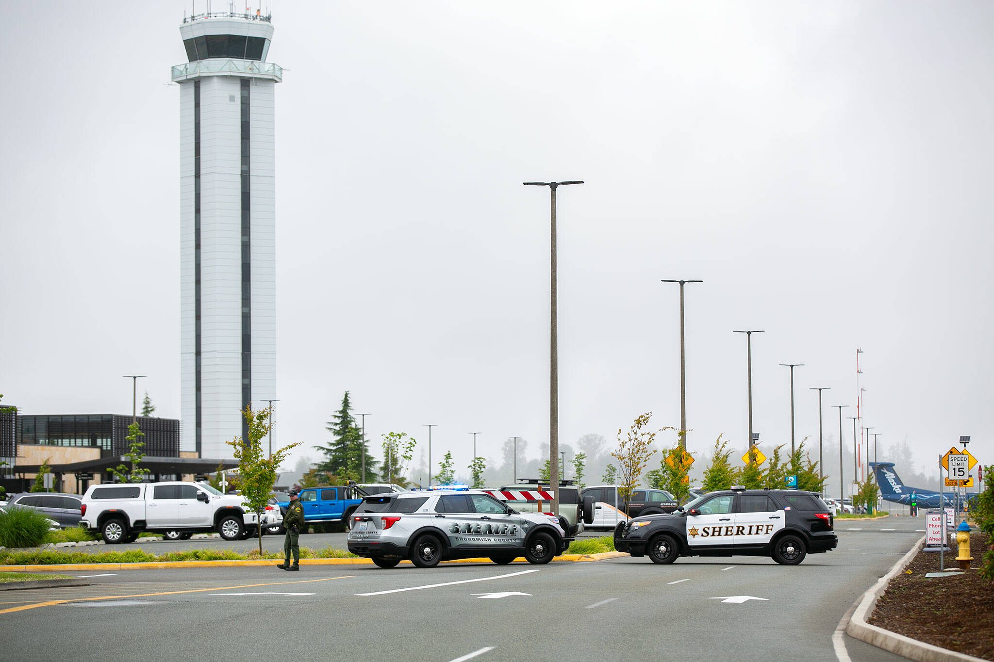 Snohomish County Sheriff vehicles block off access to Paine Field after the discovery of a suspicious package at the airport on Tuesday, June 13, 2023, in Everett, Washington. (Ryan Berry / The Herald)