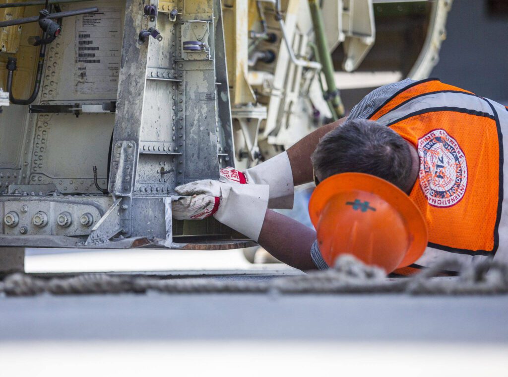 Omega Morgan employees helps navigates the fuselage into place at the Advance Manufacturing Skill Center on Thursday, June 15, 2023 in Everett, Washington. (Olivia Vanni / The Herald)
