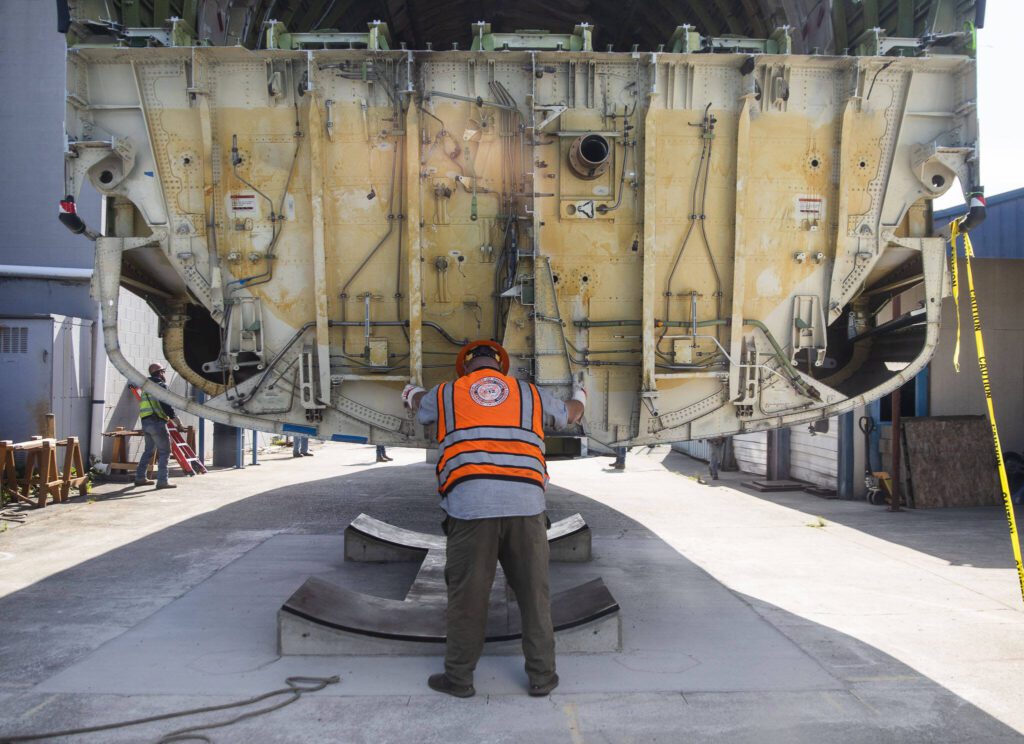 Omega Morgan employees helps navigates the fuselage into place at the Advance Manufacturing Skill Center on Thursday, June 15, 2023 in Everett, Washington. (Olivia Vanni / The Herald)
