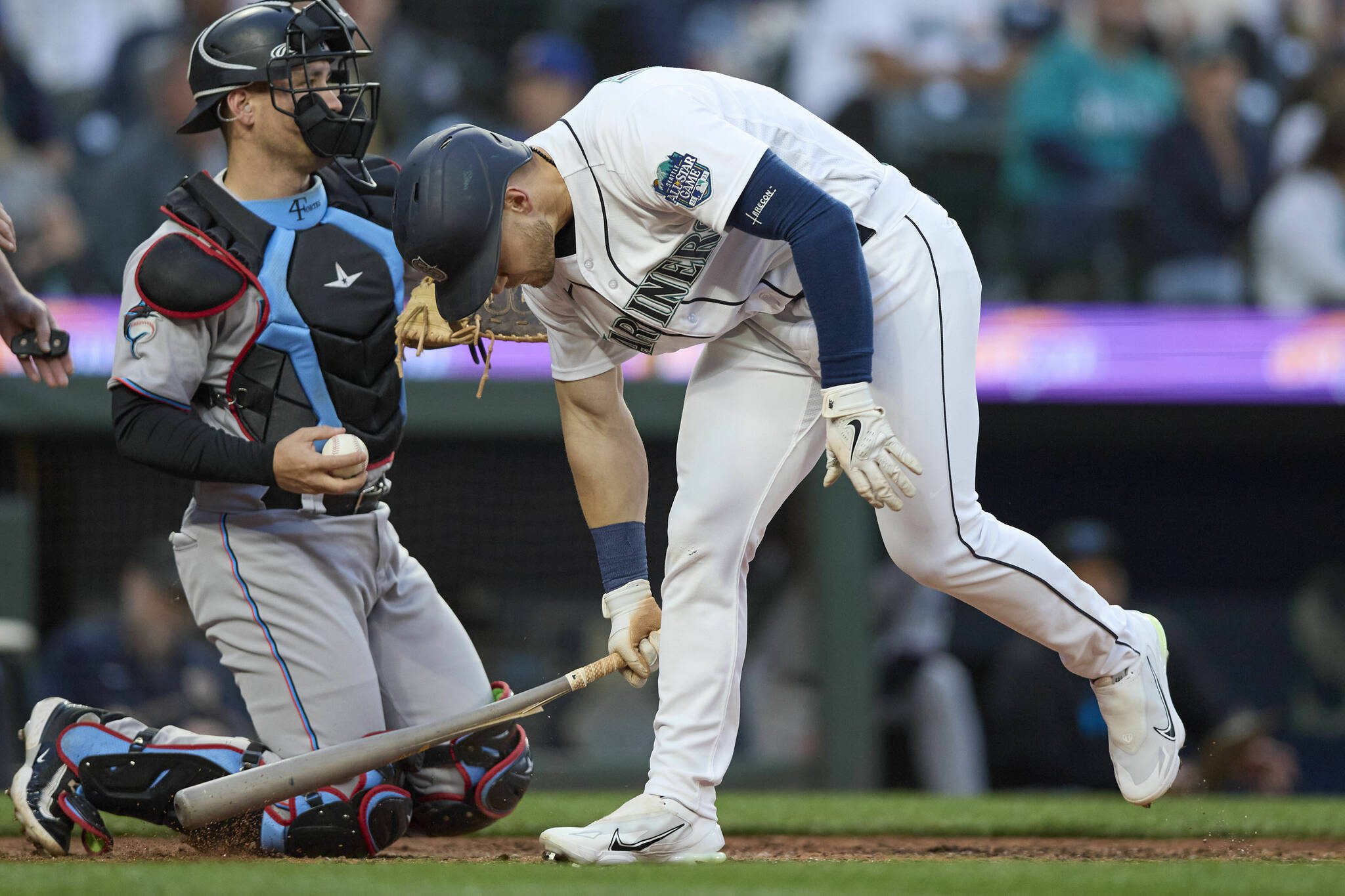 The Mariners’ Jarred Kelenic cracks his bat as he reacts to striking out against the Marlins during the seventh inning of a game Wednesday in Seattle. (AP Photo/John Froschauer)