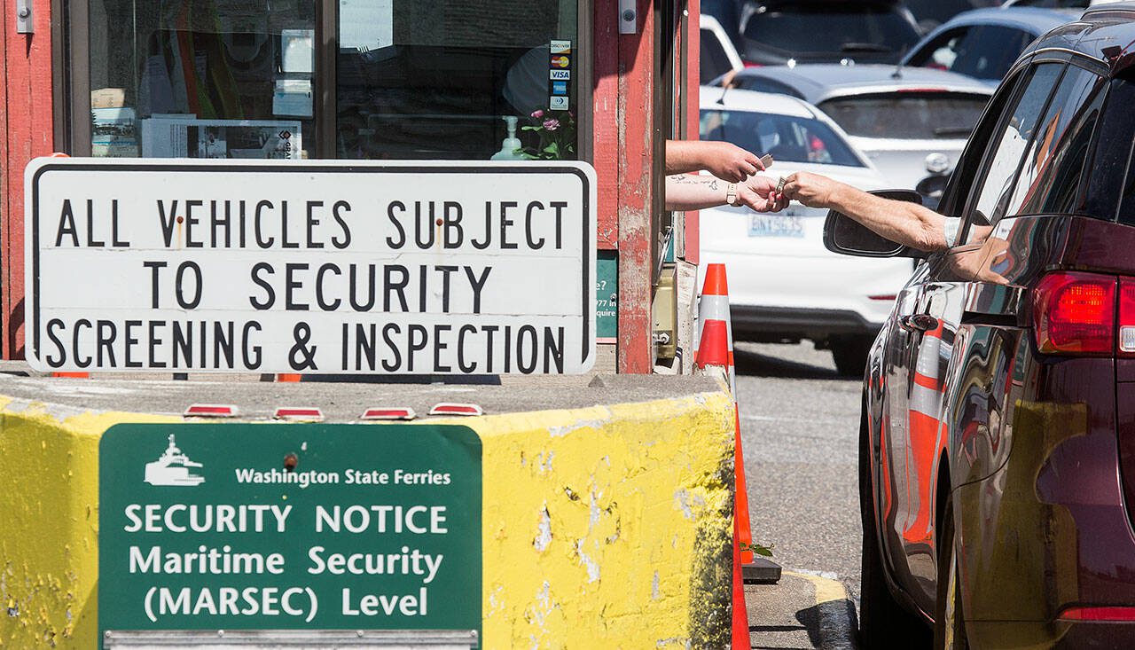 A driver buys a ticket at the former Mukilteo ferry toll booth on Aug. 6, 2019 in Mukilteo. (Andy Bronson / The Herald)