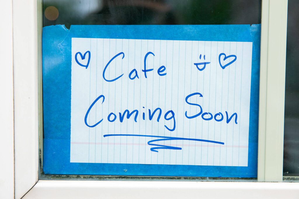 A small sign is posted in the window at 1709 Hewitt Ave. as major renovations are underway to create a new home for Catalyst Café on Tuesday, June 20, 2023, in downtown Everett, Washington. (Ryan Berry / The Herald)

