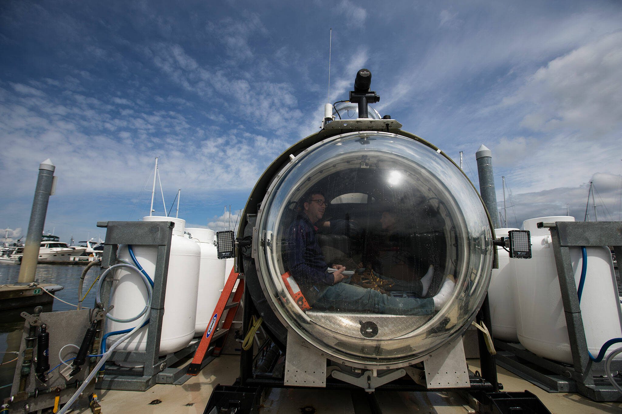 Waiting to dive below the surface, Josh Dean looks out the front dome of the OceanGate sub Cyclops1 in the Port of Everett Marina on Thursday, May 18, 2017 in Everett, Washington. (Andy Bronson / The Herald)