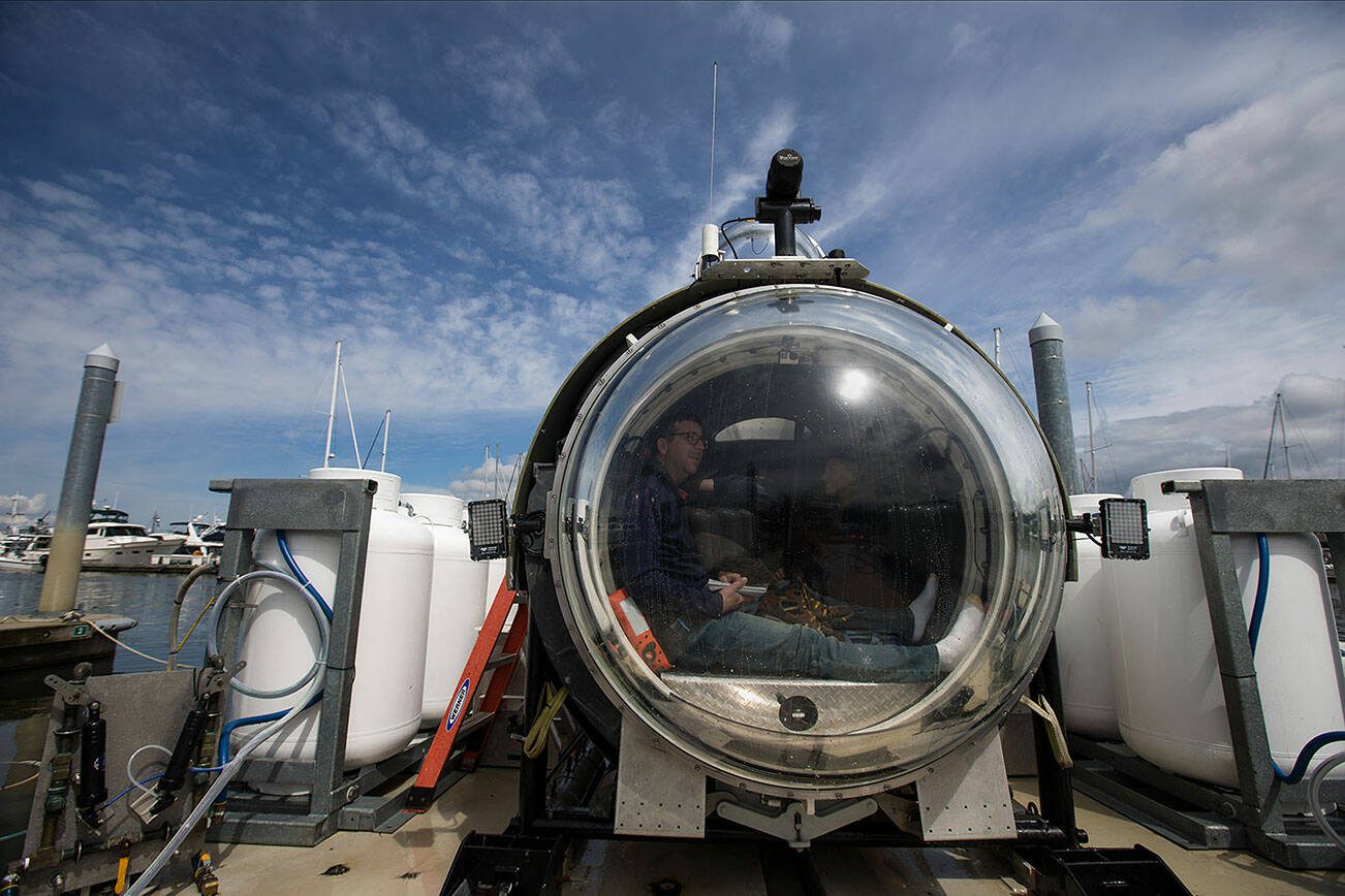 Waiting to dive below the surface, Josh Dean looks out the front dome of the OceanGate sub Cyclops1 in the Port of Everett Marina on Thursday, May 18, 2017 in Everett, Wa. OceanGate plans to carry paying customers on dives to the RMS Titanic in 2018. (Andy Bronson / The Herald)