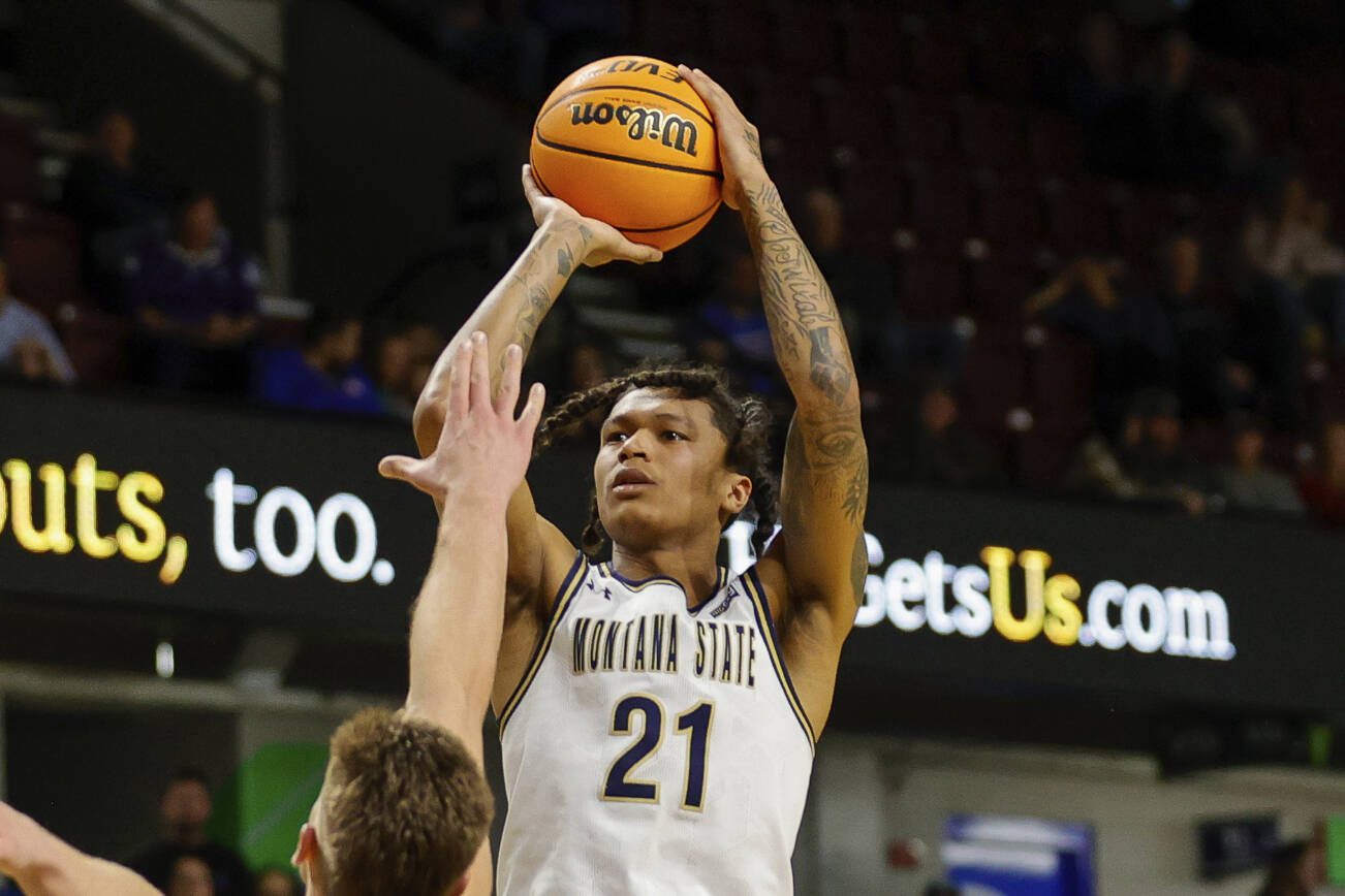 Montana State guard RaeQuan Battle (21 puts up a shot over Northern Arizona forward Carson Towt (33) in the first half of an NCAA college basketball game for the championship of the Big Sky men's tournament in Boise, Idaho, Wednesday, March 8, 2023. (AP Photo/Steve Conner)