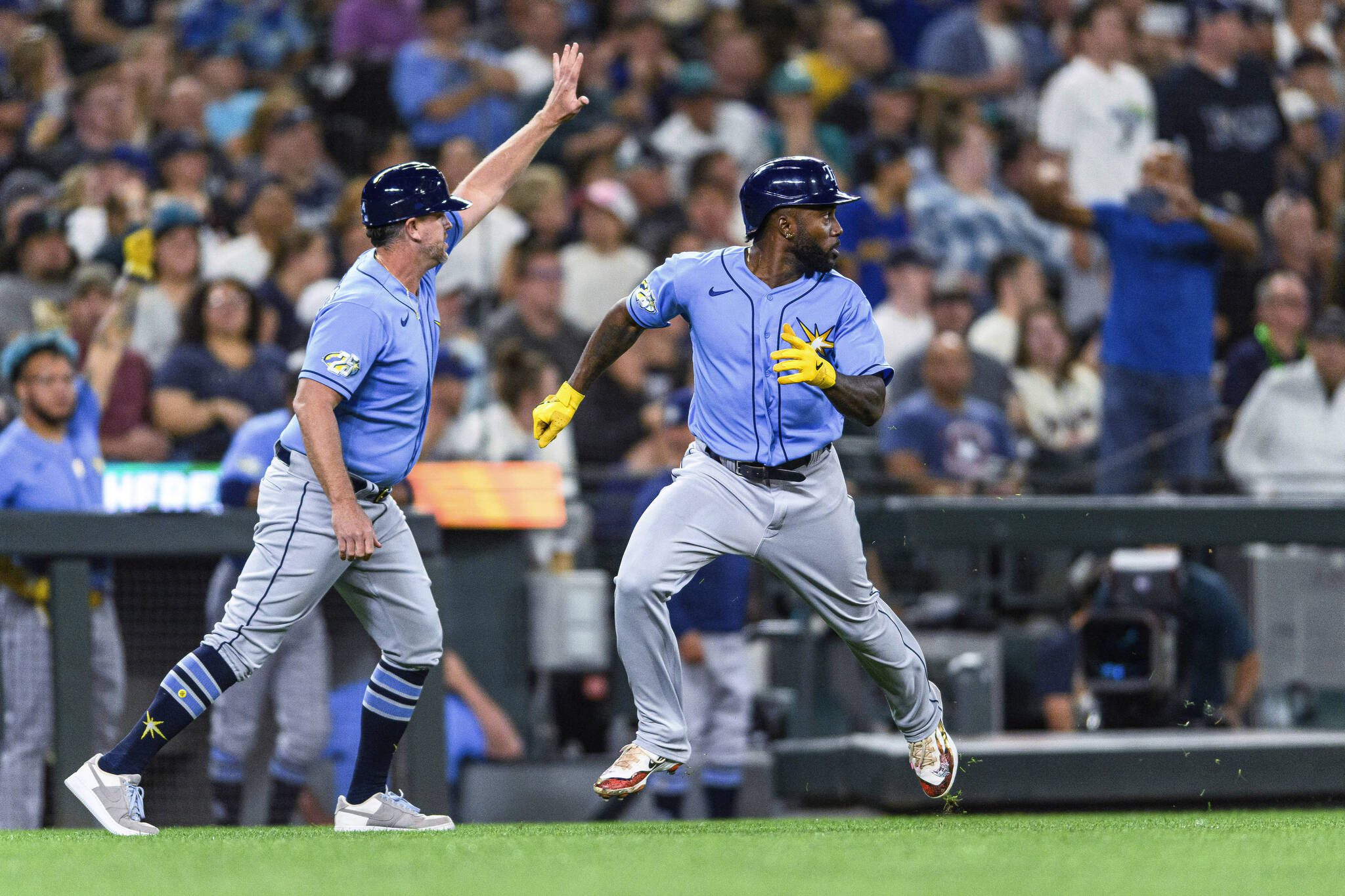 The Rays’ Randy Arozarena looks back while heading home to score against the Mariners during the eighth inning of a game Friday in Seattle. (AP Photo/Caean Couto)