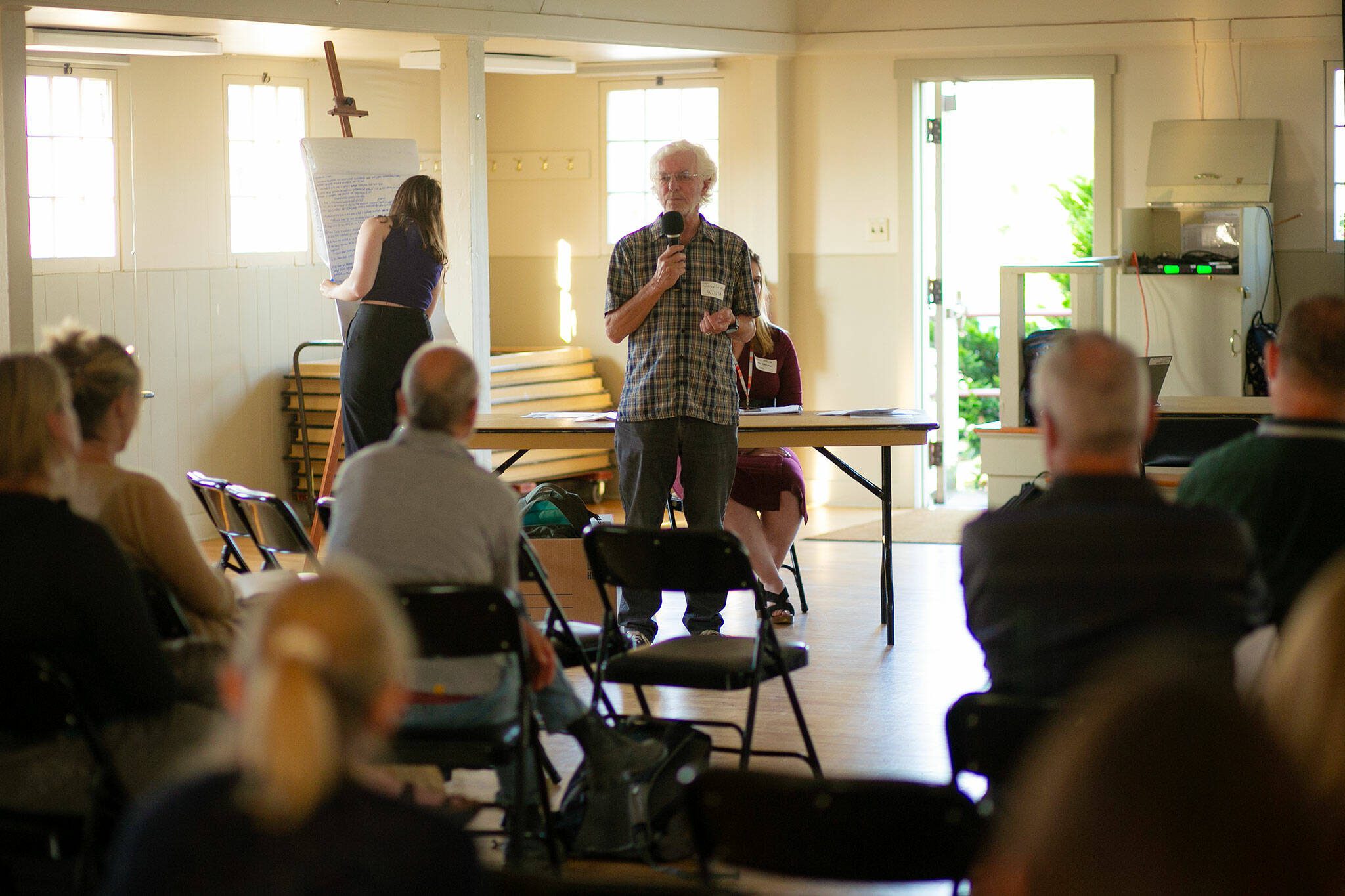 John Lovie, director of the Whidbey Island Water Systems Association, speaks to around 20 residents — mainly from the Harrington Lagoon neighborhood — during a public meeting regarding PFAS found in the drinking water of multiple Island County communities on June 22, 2023, at the Coupeville Recreation Hall in Coupeville, Washington. (Ryan Berry / The Herald)
